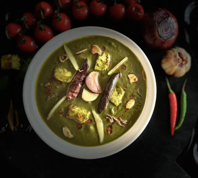 Bowl of home-made green curry with vegetables and spices
