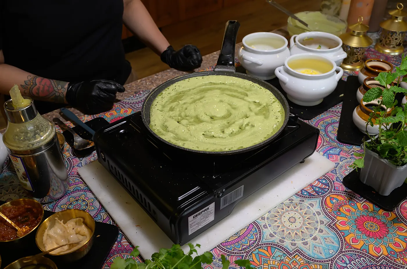 Green herb batter spread thin on the pan