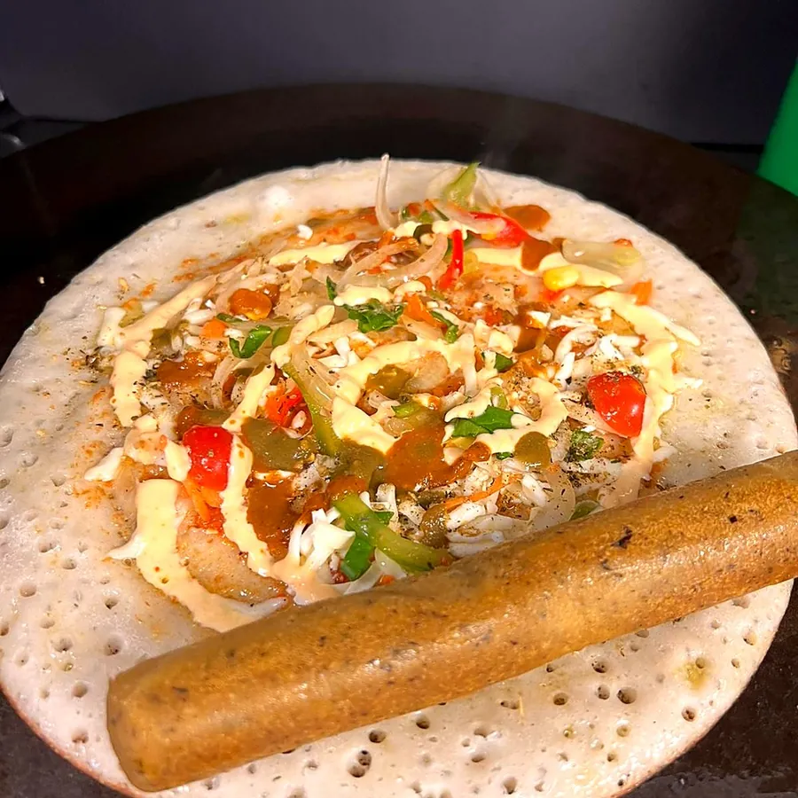 Vegan sausage on an open pancake with salad and sauces
