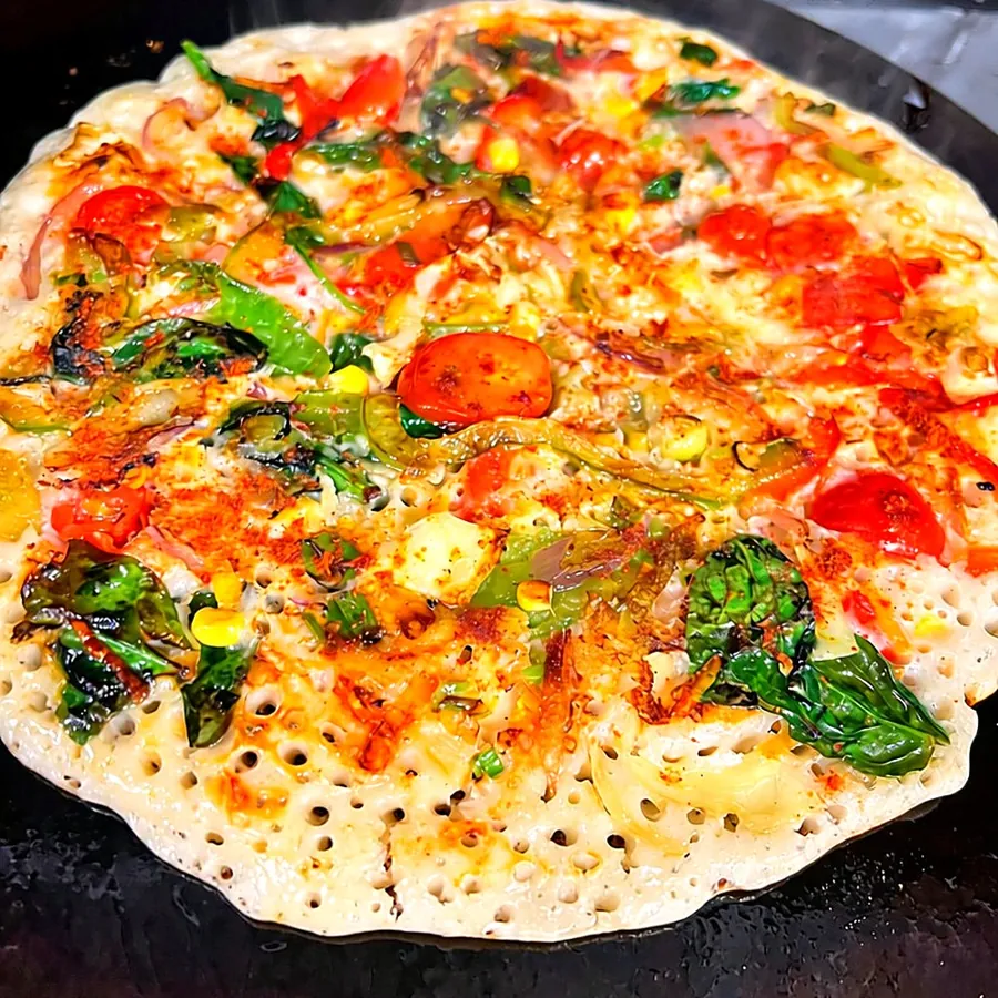 Veggie burst pancake topped with colourful vegetables on the hot plate