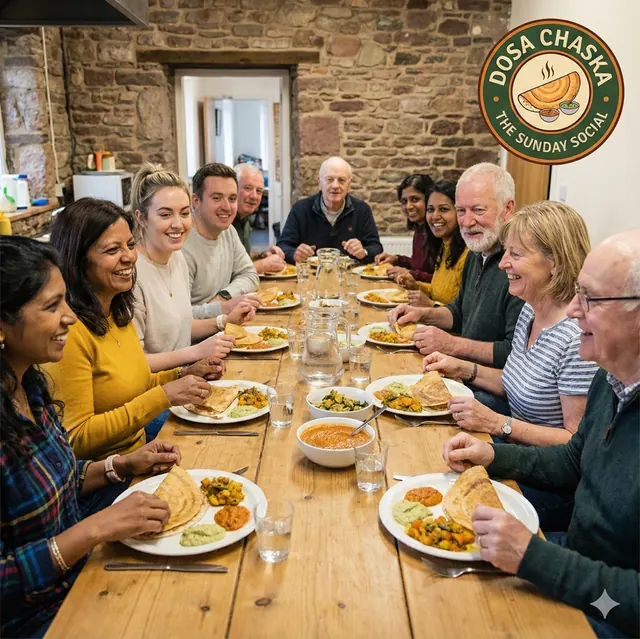 Guests sharing food at a long table at a Dosa Chaska Sunday Social
